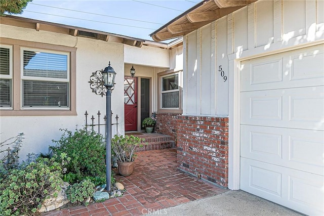 view of exterior entry featuring a garage