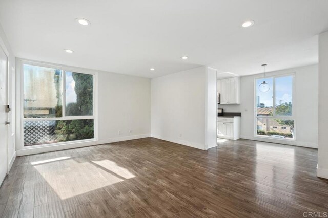 unfurnished living room featuring dark hardwood / wood-style floors