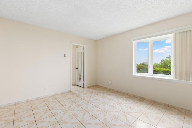 unfurnished room with a textured ceiling