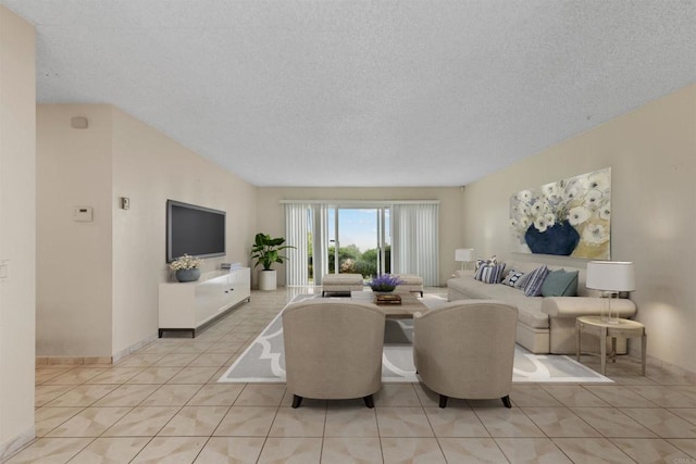 living room featuring light tile patterned flooring and a textured ceiling