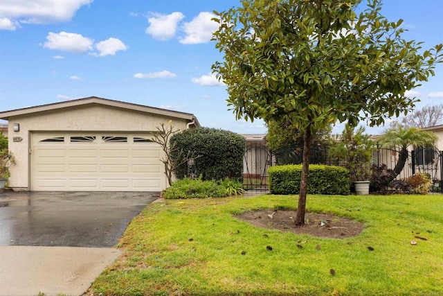 view of front of house with a garage and a front lawn