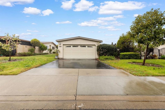 single story home featuring a garage and a front lawn