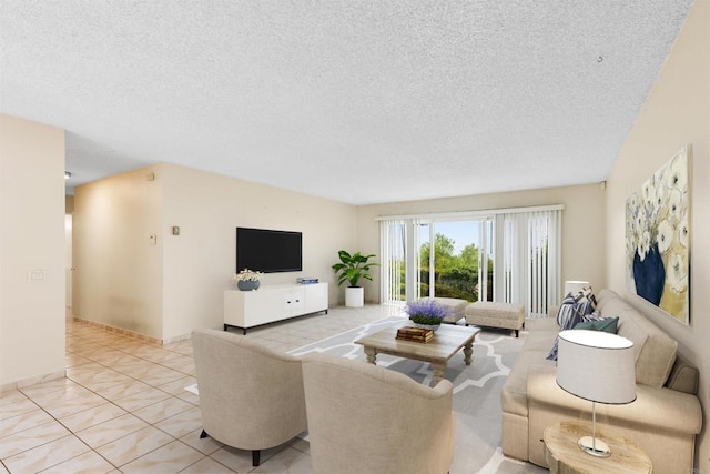 living room with a textured ceiling and light tile patterned flooring