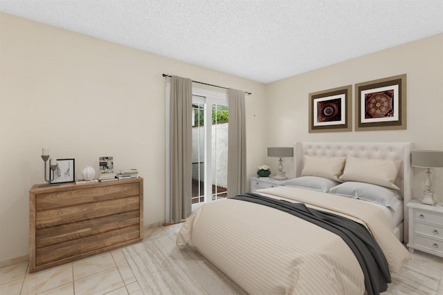 bedroom featuring light tile patterned flooring, a textured ceiling, and access to outside