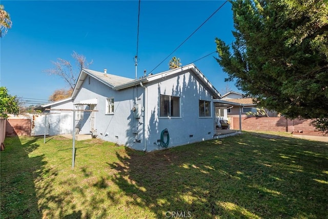 back of house with a yard