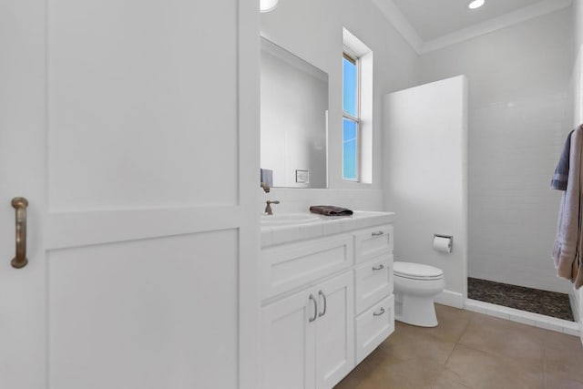 bathroom featuring tiled shower, tile patterned floors, toilet, ornamental molding, and vanity