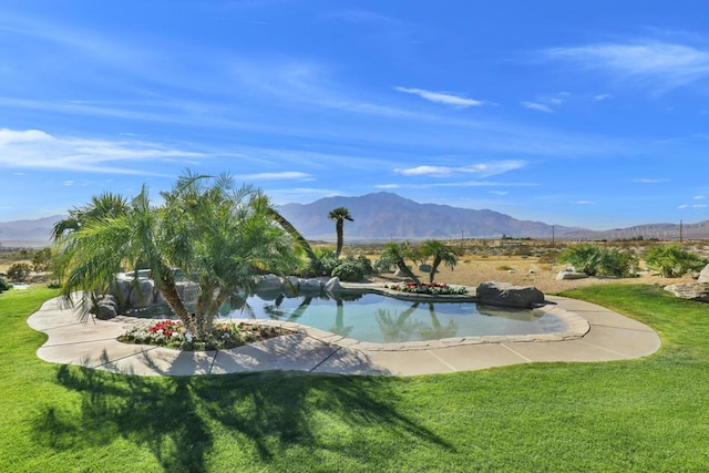 view of home's community featuring a mountain view, a lawn, and a pool