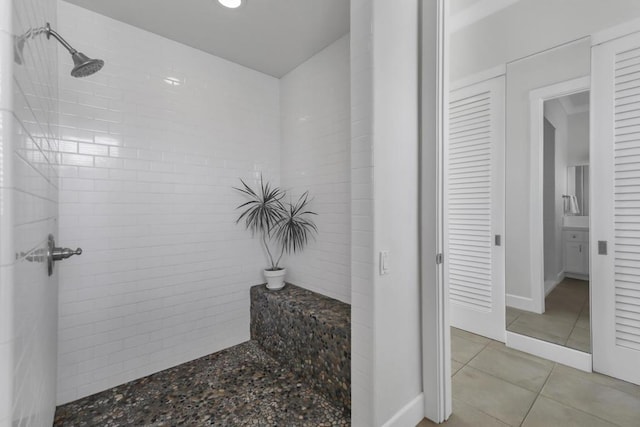 bathroom with tile patterned floors and a tile shower