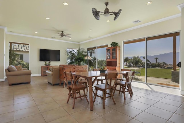 tiled dining space featuring ornamental molding and ceiling fan