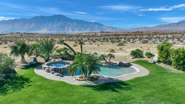 view of swimming pool featuring a mountain view, an in ground hot tub, and a lawn