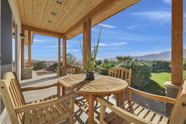 exterior space with a mountain view and wood ceiling