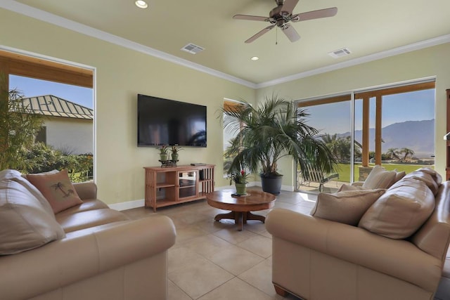 living room featuring crown molding, ceiling fan, and light tile patterned flooring