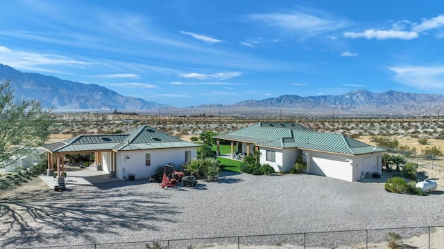 ranch-style home with a mountain view and a garage