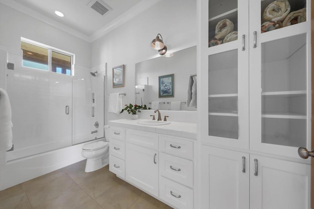 full bathroom featuring vanity, toilet, tile patterned flooring, and combined bath / shower with glass door