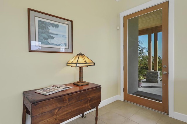 doorway to outside with light tile patterned floors