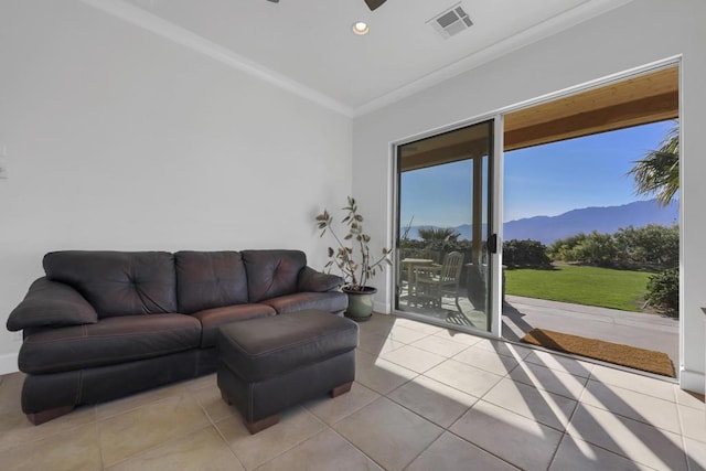 tiled living room featuring crown molding and a mountain view