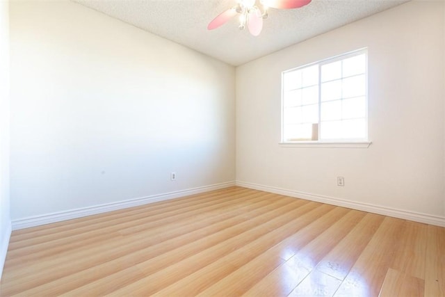 spare room featuring a textured ceiling, ceiling fan, and light hardwood / wood-style floors