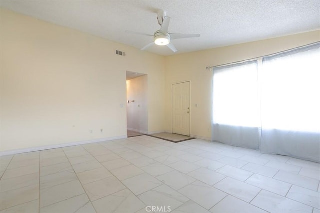 spare room with ceiling fan and a textured ceiling