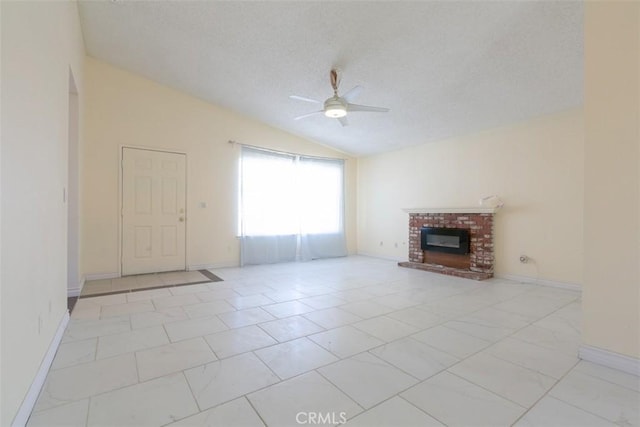 unfurnished living room featuring ceiling fan, vaulted ceiling, and a brick fireplace