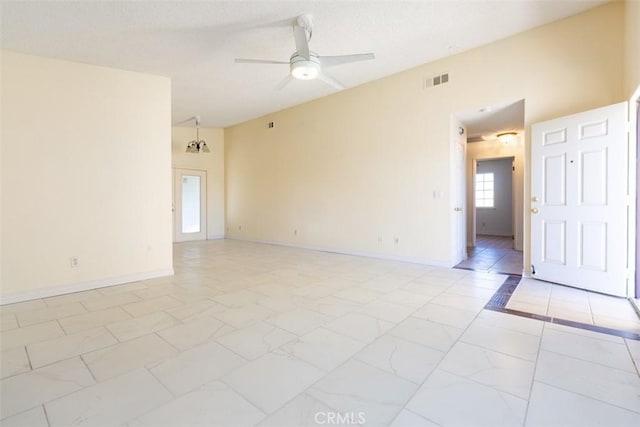 unfurnished room featuring ceiling fan with notable chandelier