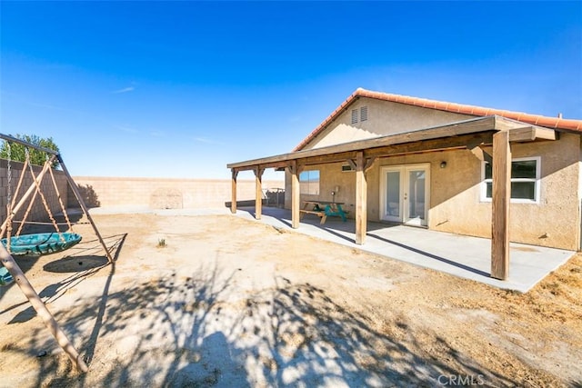 rear view of property featuring french doors and a patio