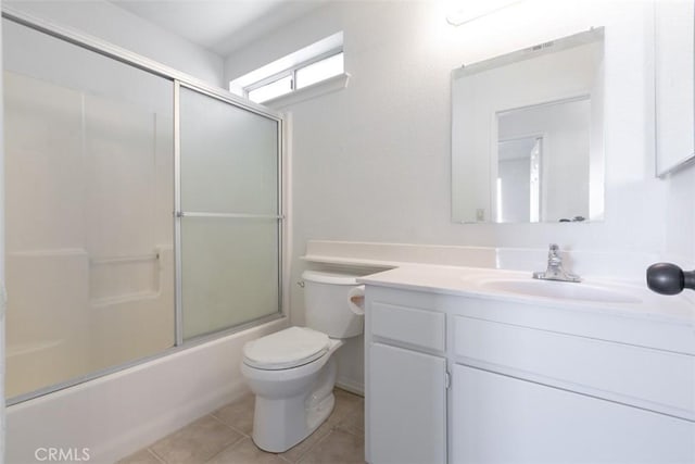 full bathroom with toilet, vanity, tile patterned floors, and shower / bath combination with glass door