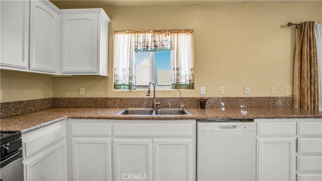 kitchen with dishwasher, sink, white cabinets, dark stone counters, and range