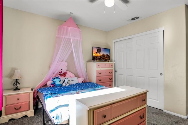 bedroom featuring ceiling fan, a closet, and dark carpet