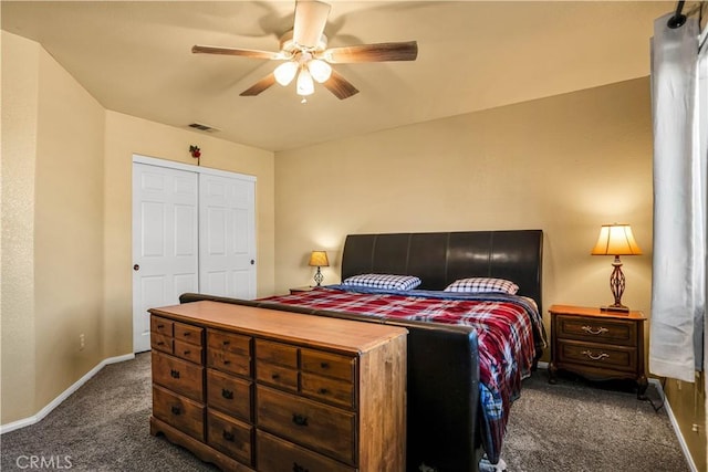 bedroom with ceiling fan, a closet, and dark carpet