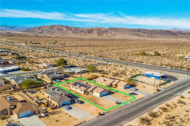 birds eye view of property with a mountain view