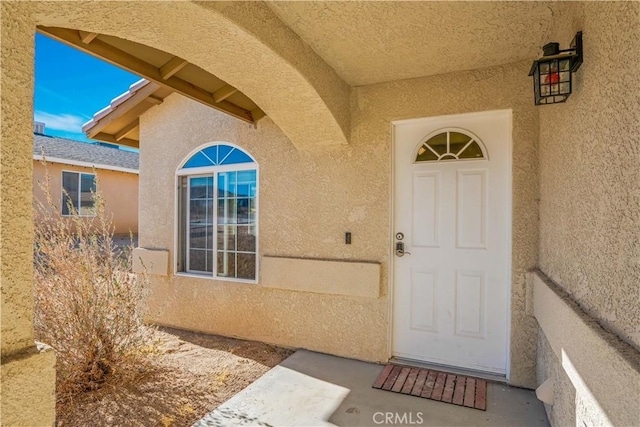 entrance to property featuring a patio area