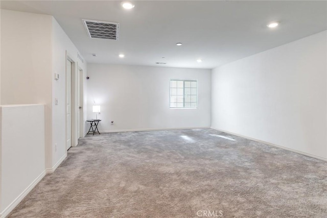 unfurnished room featuring carpet floors, recessed lighting, visible vents, and baseboards