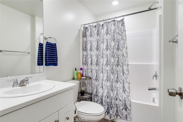 bathroom featuring toilet, shower / bath combo, and vanity