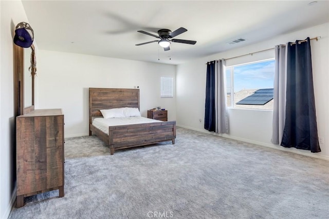 bedroom with baseboards, visible vents, ceiling fan, and light colored carpet