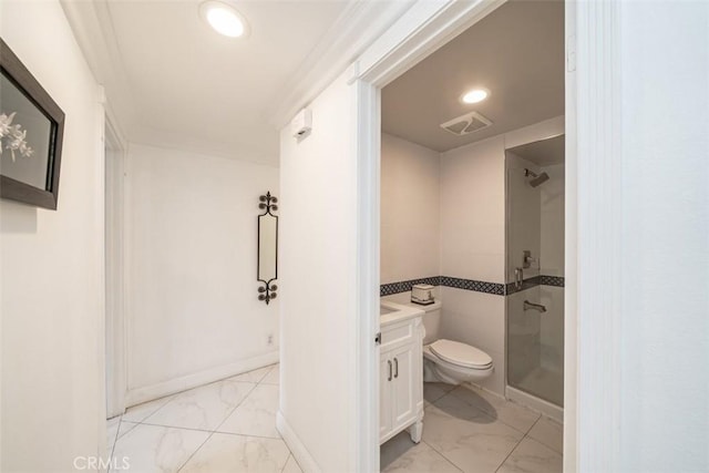 bathroom featuring a shower with shower door, toilet, and vanity