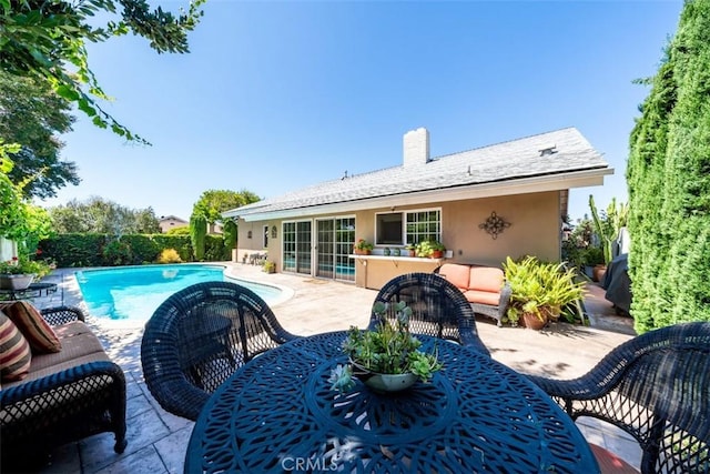 back of house with an outdoor hangout area and a patio area