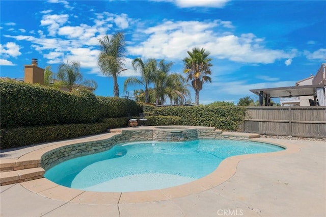 view of pool with an in ground hot tub and a patio