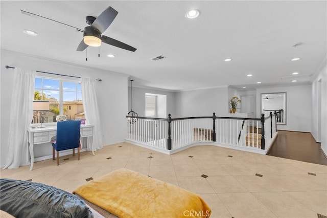 interior space featuring ceiling fan, plenty of natural light, tile patterned floors, and ornamental molding