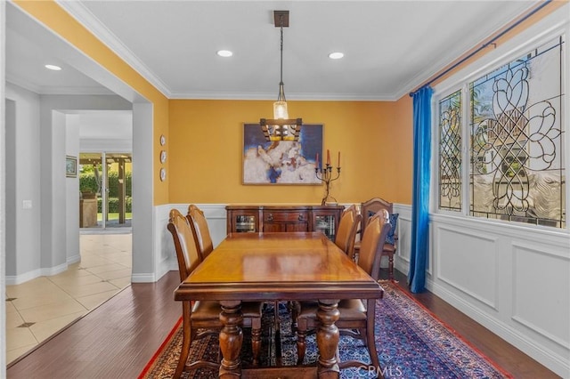 dining area featuring dark tile patterned flooring and ornamental molding