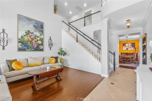 living room featuring light tile patterned floors and ornamental molding