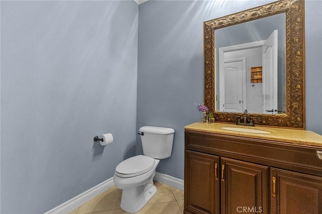 bathroom featuring toilet, vanity, and tile patterned floors