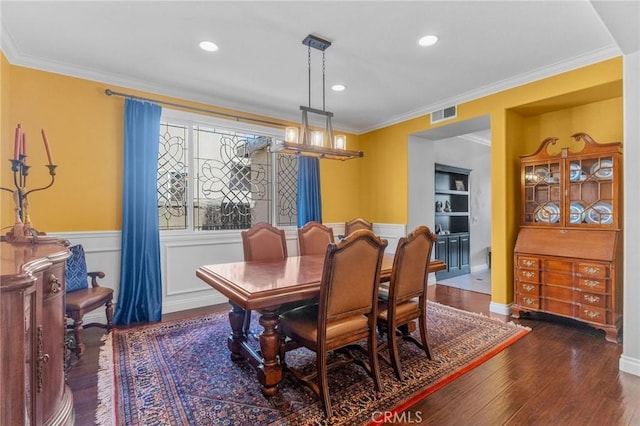 dining room featuring built in features, crown molding, and dark hardwood / wood-style floors