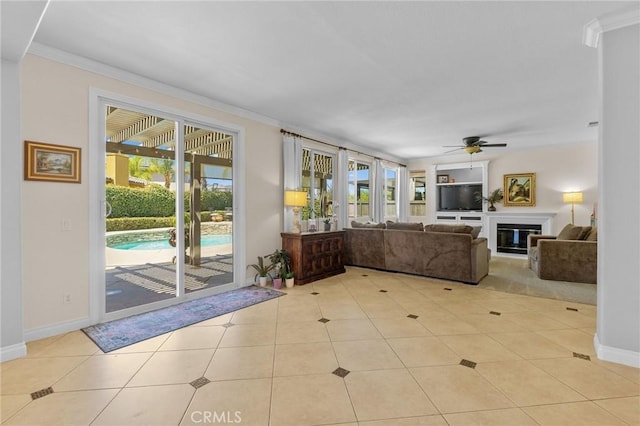 unfurnished living room featuring ceiling fan, built in features, and crown molding