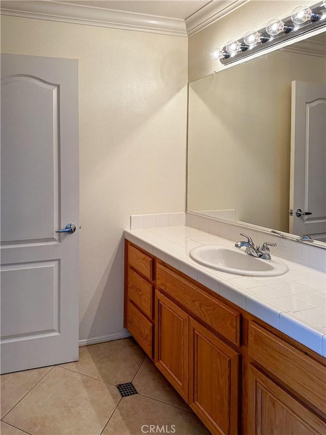 bathroom featuring crown molding, tile patterned floors, and vanity