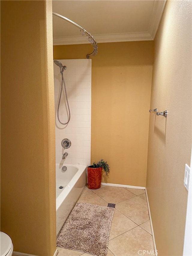 bathroom featuring toilet, tiled shower / bath combo, tile patterned flooring, and crown molding