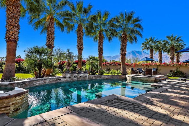 view of pool featuring a patio and a mountain view