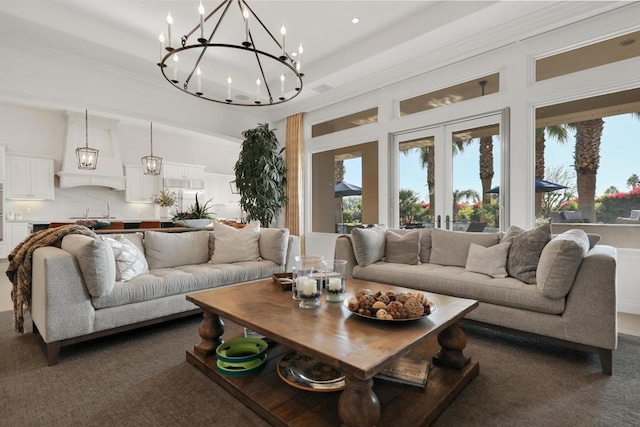 carpeted living room with ornamental molding and french doors