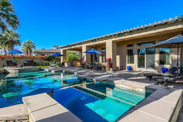 view of swimming pool with a patio and an in ground hot tub