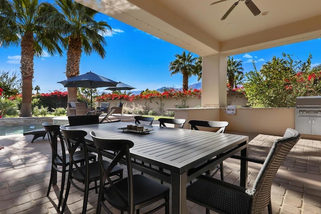 view of patio featuring area for grilling and ceiling fan