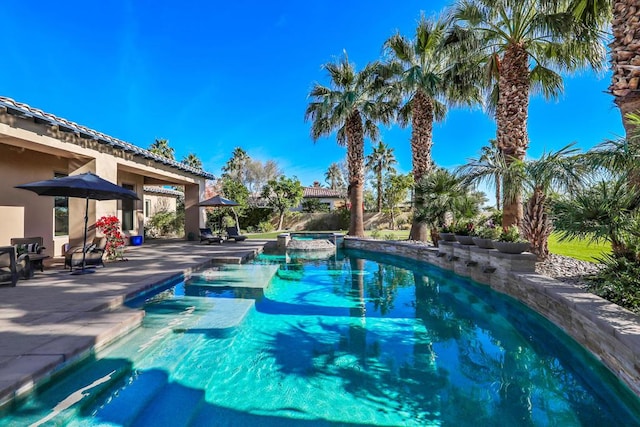 view of swimming pool featuring an in ground hot tub and a patio area